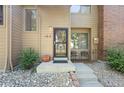 Inviting entryway with modern door, small patio, and well-kept landscaping at 424 Wright St # 102, Lakewood, CO 80228