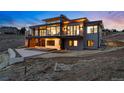 Contemporary home boasting multiple balconies with floor-to-ceiling windows overlooking backyard at 545 Strada Rossa Rd, Golden, CO 80401