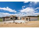 Striking modern home featuring a spacious driveway leading to a multi-car garage with stylish wood-tone doors at 545 Strada Rossa Rd, Golden, CO 80401