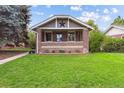 Brick home with a charming front yard and star detail at 1431 S Emerson St, Denver, CO 80210