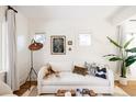 White living room with hardwood floors and a cozy sofa at 1431 S Emerson St, Denver, CO 80210