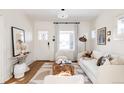 Light-filled living room, hardwood floors, and comfy seating at 1431 S Emerson St, Denver, CO 80210