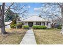 Inviting front entrance with a covered porch and neatly trimmed bushes at 3201 S Albion St, Denver, CO 80222