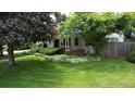 Charming home featuring a lush green lawn and mature trees in a serene front yard setting at 3201 S Albion St, Denver, CO 80222