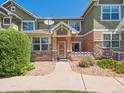 Charming townhome exterior with stone accents, a quaint porch, and well-maintained landscaping enhancing curb appeal at 3662 S Perth Cir # 104, Aurora, CO 80013