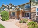 Inviting townhome exterior featuring stone accents, a cozy porch area, and manicured landscaping for a welcoming appeal at 3662 S Perth Cir # 104, Aurora, CO 80013