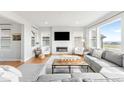 Spacious living area featuring a fireplace, large windows, and stylish decor at 17786 W 86Th Ln, Arvada, CO 80007