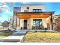 Contemporary home featuring a stylish covered porch, modern architecture, and well-manicured landscaping at 1100 S Gilpin St, Denver, CO 80210