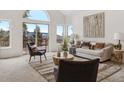 Inviting living room with comfortable seating, stylish decor, and a large sliding glass door to the outside deck at 1580 Santa Fe Mountain Rd, Evergreen, CO 80439