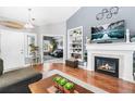 Inviting living room with hardwood floors, a fireplace, built-in shelving, and stylish decor at 19771 E Wesley Pl, Aurora, CO 80013