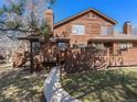 A rustic exterior of a brown home with a stone walkway and manicured lawn at 9365 W 80Th Pl # C, Arvada, CO 80005