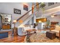 Inviting living room with vaulted ceilings, open staircase, and hardwood floors at 9365 W 80Th Pl # C, Arvada, CO 80005