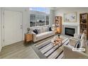 Bright living room featuring a fireplace, large windows, and modern furnishings at 8199 Welby Rd # 1908, Denver, CO 80229