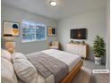 Cozy bedroom with a large window, a soft bed, and stylish decor at 8199 Welby Rd # 1908, Denver, CO 80229