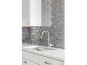 Kitchen sink and light gray subway tile backsplash at 7877 E Mississippi Ave # 901, Denver, CO 80247