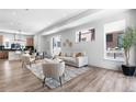 Bright living room featuring wood floors, modern furniture, and large windows offering ample natural light at 9066 Harlan St, Westminster, CO 80031