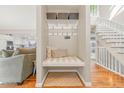 Built-in bench seating with storage and coat hooks in a light-filled entryway at 5875 E Weaver Cir, Centennial, CO 80111