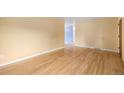 Spacious living room boasts beautiful hardwood floors, neutral wall color, and ample natural light at 5502 E Center Ave, Denver, CO 80246