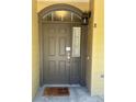 Elegant front door with transom window, stylish hardware, and warm lighting, enhancing curb appeal at 11207 Osage Cir # B, Northglenn, CO 80234
