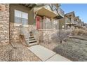 Townhome entrance with stone steps and landscaping at 18847 E Yale Cir # D, Aurora, CO 80013