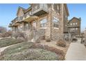 Townhome with stone and siding, showcasing multiple units at 18847 E Yale Cir # D, Aurora, CO 80013