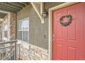 Red front door with a wreath and stone surround at 18847 E Yale Cir # D, Aurora, CO 80013