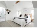 Bright bedroom featuring neutral decor, a comfortable bed, and a view of the ensuite bathroom at 840 S Pennsylvania St, Denver, CO 80209