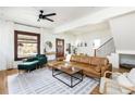 Bright living room with hardwood floors, a large leather sectional sofa, and ample natural light at 840 S Pennsylvania St, Denver, CO 80209