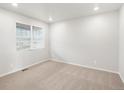 Bright, carpeted bedroom with a large window at 8807 Sedalia St, Commerce City, CO 80022