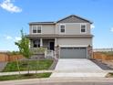 Two-story home featuring stone accents and a two-car garage on a sunny day at 8807 Sedalia St, Commerce City, CO 80022