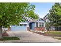 Charming blue home with a two-car garage, manicured lawn, and appealing curb appeal at 1118 S Duquesne Cir, Aurora, CO 80018