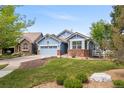 Beautiful single-Gathering home featuring an attached garage, lawn, and cozy front porch at 1118 S Duquesne Cir, Aurora, CO 80018