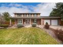 Attractive two-story home with a covered porch, brick accents, and a well-kept front yard at 8510 Independence Way, Arvada, CO 80005