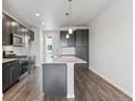 Modern kitchen with dark cabinets, quartz countertops and stainless steel appliances at 453 Interlocken Blvd # 103, Broomfield, CO 80021