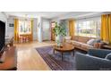 Bright, open living space with hardwood floors, large windows, and stylish furnishings at 1842 S Fairfax St, Denver, CO 80222