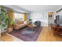 Comfortable living room with hardwood floors, a leather couch, and ample natural light at 1842 S Fairfax St, Denver, CO 80222
