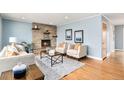 Inviting living room featuring a stone fireplace, comfortable seating, and stylish decor at 3276 S Osceola St, Denver, CO 80236