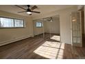 Bright bedroom featuring wood floors, ceiling fan, sliding mirror closet doors and a window at 1270 N Marion St # 103, Denver, CO 80218