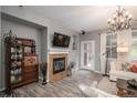 Living room with fireplace, built-ins and hardwood floors at 3512 Cascina Pl # A, Highlands Ranch, CO 80126