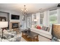 Living room with fireplace, TV and comfy seating at 3512 Cascina Pl # A, Highlands Ranch, CO 80126