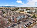 Aerial view of condo complex showcasing building and surrounding neighborhood with mountain backdrop at 2428 W 82Nd Pl # 2D, Westminster, CO 80031