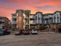 Exterior view of the three-story condo complex, with multiple balconies and ample parking at 2428 W 82Nd Pl # 2D, Westminster, CO 80031