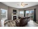 Living room with wood floors, a fireplace, and sliding glass doors to a balcony at 2428 W 82Nd Pl # 2D, Westminster, CO 80031