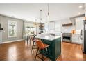 Modern kitchen featuring a large island with seating, stainless steel appliances, and a bright breakfast nook at 743 Briar Haven Dr, Castle Pines, CO 80108