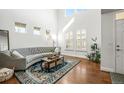 Bright living room with soaring ceilings, stylish furniture, and beautiful hardwood floors at 743 Briar Haven Dr, Castle Pines, CO 80108