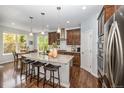 Modern kitchen with granite countertops, stainless steel appliances, and a breakfast bar with seating at 13942 W 87Th Dr, Arvada, CO 80005