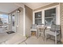 Small front porch with table and chairs at 7190 Pine Hills Way, Littleton, CO 80125