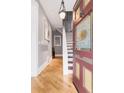 Grand foyer featuring hardwood floors, a staircase, and a decorative front door at 3147 Vallejo St, Denver, CO 80211