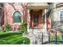 Inviting entrance with manicured artificial lawn, charming patio seating, and lovely garden area at 3147 Vallejo St, Denver, CO 80211
