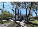 Inviting single-story house featuring a well-manicured lawn, pathway, and mature trees at 409 N Finch Ave, Lafayette, CO 80026